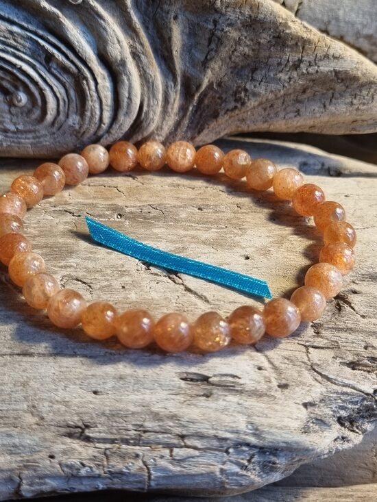 Saulesakmens rokassprādze "Depresijas atvairītājs" Izmērs 18.5 cm Bumbiņa 7 mm Zila bantīte