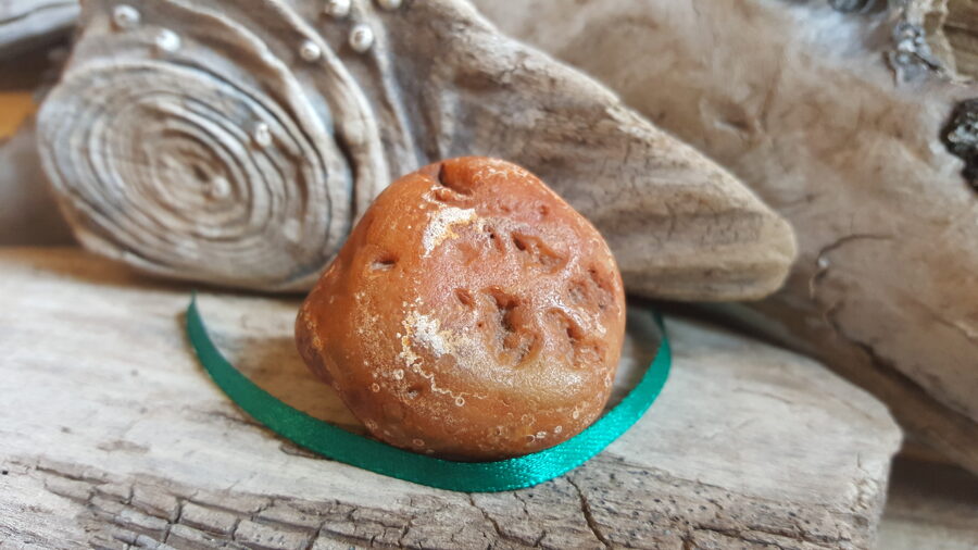 Karneola olis dabīgi noapaļojies "Stiprais palīgs" Izmērs 4 x 4 x 2.5 cm Zaļa bantīte